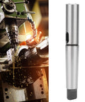 MT4–MT2 taper drill sleeve adapter in steel; left shows lathe setup, right shows the cylindrical adapter.