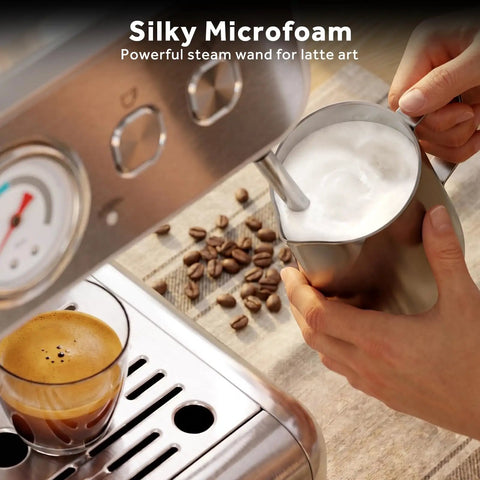 Top Tier 58mm Espresso Machine With Integrated Conical Burr Grinder steaming milk for microfoam, with espresso and coffee beans nearby.