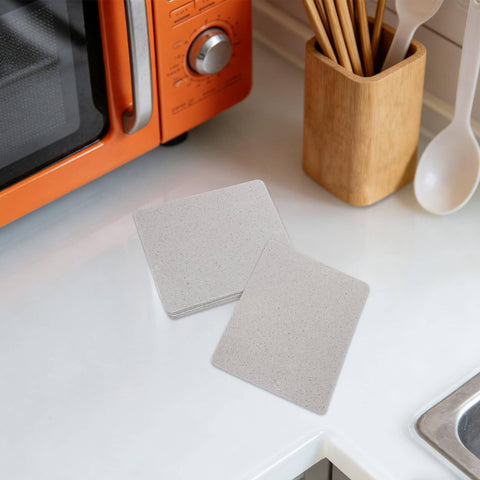 Mica Insulation Sheet 10 Pack For Microwave And Oven Repair Heat Resistant Fireproof Dielectric Board on kitchen counter.