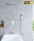 All-In-One Tub And Shower Faucet Set In Brushed Nickel With 12-Inch Rainfall Shower Head Waterfall Tub Spout And Rough-In Valve Complete Bath Trim Kit For An Easy, No-Brainer Upgrade installed above bathtub.