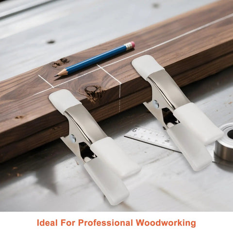 Beastly Grip Heavy Duty 4 Inch Spring Clamps securing a wooden plank with pencil and ruler on a workbench.
