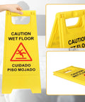 Heavy Duty Folding Wet Floor Signs, Set Of Twelve Double Sided Bilingual Safety Placards For Shop And Office Floors, Bold Yellow Warning Markers Ready To Roll With Zero Fuss And Rock Solid Build - Foldable yellow sign held in hand.