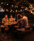 Evening gathering under Lit 50 Foot Outdoor LED String Lights With 27 Plastic G40 Bulbs And 2 Spare, glowing in a backyard.