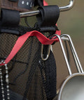 Close-up of Desktop Trash Can Holder And Hanging Rack Organizer for Home And Camping, showing metal hook and fabric straps.