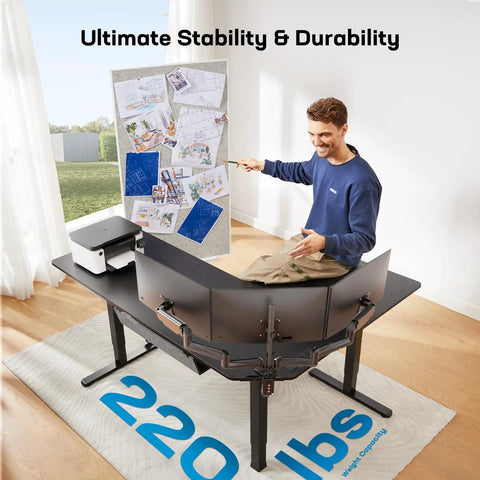 Man sitting on 63-Inch L-Shaped Standing Desk With Built-In Power Outlets And Large Power Strip Holder