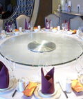 Round Tempered Glass Lazy Susan For Dining Table 31 To 43 Inch With Smooth Edges And Heavy Duty High Load Capacity Large Transparent Turntable Serving Plate For Effortless Table Service on a set dining table with napkins and glasses