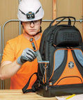 Person using Digital Angle Finder 3 In 1 For Inside And Outside Angles with backpack at construction site