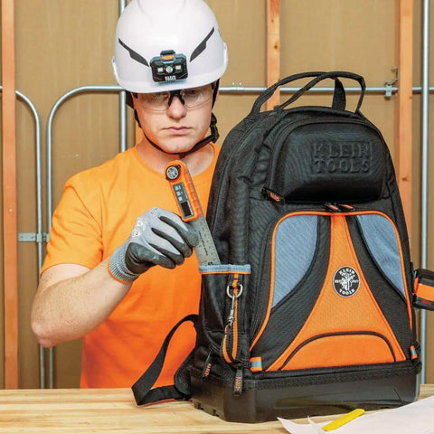 Person using Digital Angle Finder 3 In 1 For Inside And Outside Angles with backpack at construction site