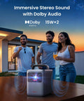 Three people enjoying music with portable speaker featuring immersive stereo sound and Dolby Audio outdoors at sunset.