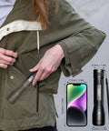 Person placing Beast Bright 900 Lumen Tactical Flashlight with Zoomable Beam into a jacket pocket, size comparison with phone.