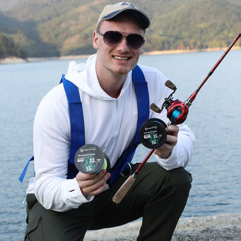 Man holding Beast Mode Baitcasting Reel With 8.1 To 1 Gear Ratio, Magnetic Braking, red right-hand casting reel