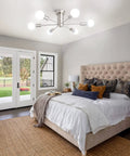 Dope Six Light Sputnik Style Ceiling Fixture In Brushed Nickel Finish illuminating a bedroom with modern decor.