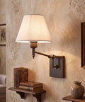 YS.ESUDSI Swing Arm Vintage Wall Sconces with White Fabric Shade Hardwired on textured wall with books and decor.