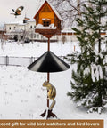 Heavy Duty Squirrel Proof Bird Feeder Baffle 19 Inch Diameter Pole Mount Shield for Outdoor Use Keeps Squirrels Off and Protects Your Feeder on a Shepherds Hook in snowy garden with bird flying