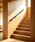 Heavy Duty Flush Wall Mount Stair Railing In Corrosion Resistant Stainless Steel With Matte Black Finish Six Foot Length mounted on wooden staircase.