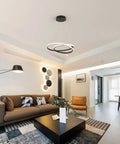 Modern LED Chandelier With Dimmable 36W Light And Remote, Black Acrylic Two Ring Pendant Hanging Lamp in a living room setting