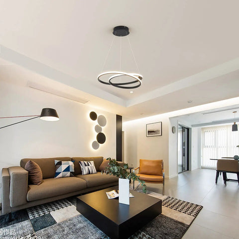 Modern LED Chandelier With Dimmable 36W Light And Remote, Black Acrylic Two Ring Pendant Hanging Lamp in a living room setting