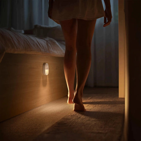 Person walking in bedroom illuminated by Must Have Rechargeable Motion Sensor Night Light Stick On LED Light USB Powered Dimmable 1 To 20 Lm