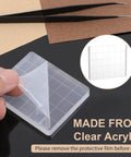 Six Clear Acrylic Stamp Blocks Set with grid lines shown with protective film being removed, ideal tool for DIY projects.