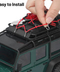 Close-up of hand installing Expedition Ready Off Road RC Rig Gear Kit For 1/18 TRX4M And 1/24 Axial SCX24 on toy truck roof