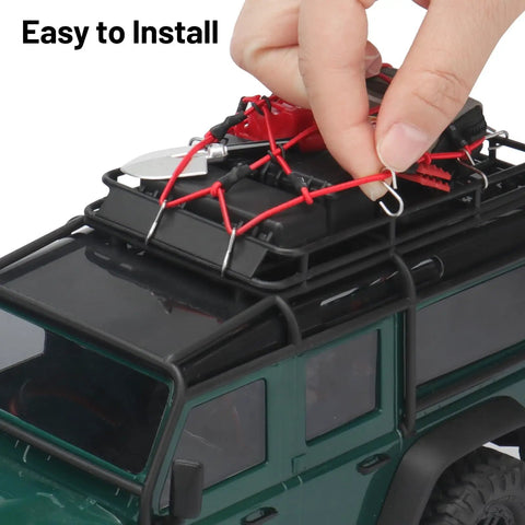 Close-up of hand installing Expedition Ready Off Road RC Rig Gear Kit For 1/18 TRX4M And 1/24 Axial SCX24 on toy truck roof