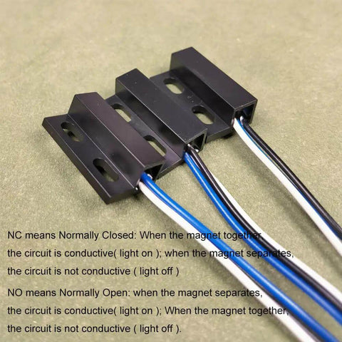 Close-up of Three Sets NO NC Black Magnetic Door Sensor Reed Switch Kit with visible cables on green surface