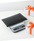 60 Pack Black Self-Sealing Bubble Mailers With Tear-Resistant PET Padding on a digital scale