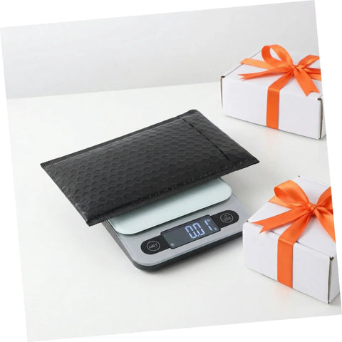 60 Pack Black Self-Sealing Bubble Mailers With Tear-Resistant PET Padding on a digital scale