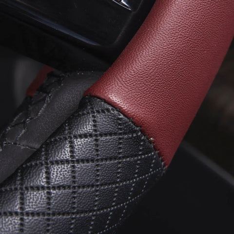 Close-up of Rhombus Microfiber Leather Steering Wheel Cover Universal Fit For Car Suv Truck Van with black and burgundy padded sides.