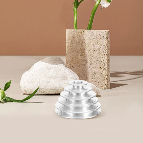 Rock Solid Five Step Drill Press Pulley Wheel With Precision Machined Bore Shaft on display with decorative stones and vase.