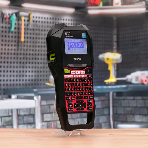 Commercial Heavy Duty Industrial Label Maker Kit Printing On Wide Heat Shrink Vinyl And Self Laminating Tape close-up view on workbench.