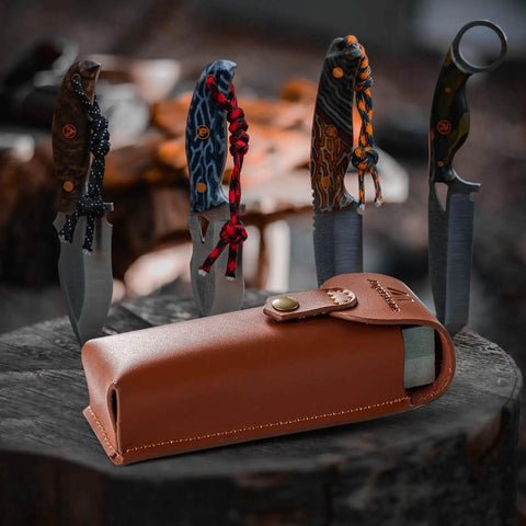 Portable Whetstone Knife Sharpener with Dual Grit 400/1000 kit in cowhide pouch beside hunting knives on wood surface