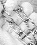 Kickass 12mm Stainless Steel Heavy Duty Chain For Campsite Anchoring Garden Fencing And Industrial Clothes Rack Hanging With Bulletproof Tensile Pull Power And Rust Resistant Finish held in gloved hand, showcasing details of link design.
