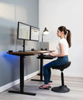 Woman using Under Desk Keyboard Tray With Pull Out Platform Extra Sturdy C Clamp Mount Big 33 Inch Wide By 11 Inch Deep Slide Out Tray