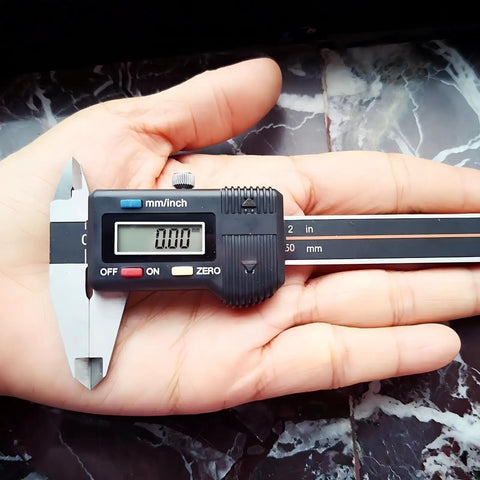 Person holding Digital Vernier Caliper 50mm 2In High Precision Measuring Tool with dual unit conversion on palm.