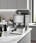 Straight Up A Heavy Hitter Home Coffee Bean Roaster on kitchen counter with stainless steel exterior and control panel.
