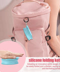 Foldable Silicone Water Bottle For Travel And Gym attached to pink backpack, showcasing compact design for on-the-go use.