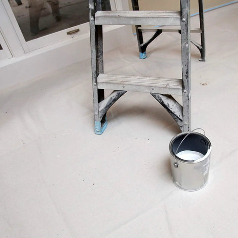 Heavy Duty 12 Ounce Canvas Drop Cloth 9 By 12 Feet For Paint Protection Indoor Outdoor Reusable Pro Grade Thick Drop Cloth That Handles Spills And Splatter With Ease covering floor under ladder and paint can.