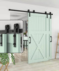 Heavy Duty Carbon Steel Sliding Barn Door Track Hardware Kit With Ceiling Mount on mint green wooden door, showing close-up hardware.