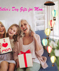 Solar Powered Wind Chimes With Hot Air Balloon Lights For Outdoors auto light up alongside happy family with gift