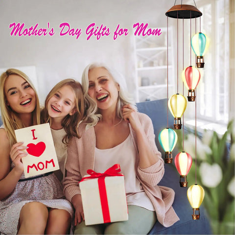 Solar Powered Wind Chimes With Hot Air Balloon Lights For Outdoors auto light up alongside happy family with gift