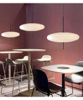 Modern Pendant Light LED Minimalist Black and White Pendant Light Restaurant Study Living Room Bedroom Home Light,Luxury(Tricolor Light,White 30cm) in a stylish setting with sleek furniture.