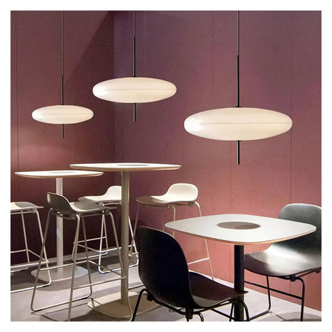 Modern Pendant Light LED Minimalist Black and White Pendant Light Restaurant Study Living Room Bedroom Home Light,Luxury(Tricolor Light,White 30cm) in a stylish setting with sleek furniture.