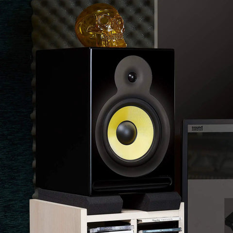 Studio monitor on heavy-duty acoustic foam cushion isolation pads reducing vibration, 5 to 12 inch fit, non-slip setup for home studios.
