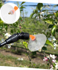 Electric Drift Guard Spray Nozzle With Transparent Windproof Shield attached to sprayer, spraying flowers in garden