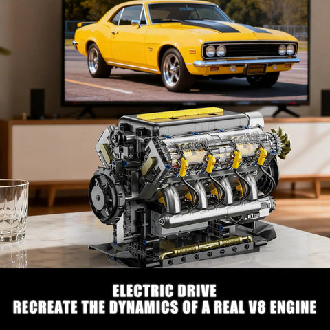 V8 Engine Model Kit That Runs with USB motor and clear pistons, on display in front of a TV showing a classic yellow car.