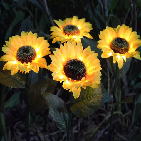 Upgraded 4 Flower Solar Sunflowers With Fairy Light Petals For Yard Decor glowing warmly in the dark