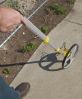 Rolatape RT312 12.5 Inch Aluminum Measuring Wheel Built To Last With Lightweight Durable Design For Landscaping And Construction, Ergonomic Pistol Grip, Yellow Great For Yards And Job Sites in use on sidewalk