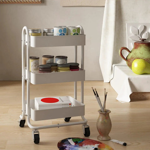 Three Tier Metal Rolling Cart With Wheels, Utility Cart On Casters For Office, Home, Kitchen Or Garden, White Finish, Lockable Casters For Stability, Easy Move And Flexible Storage, with art supplies in a room setting.