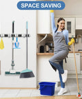 Stainless Steel Wall Mounted Broom And Mop Holder With Five Racks And Four Hooks Self Adhesive Heavy Duty Storage Organizer in kitchen